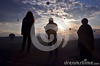 Silhouette of people looking at morning flight of passenger ball Stock Photo