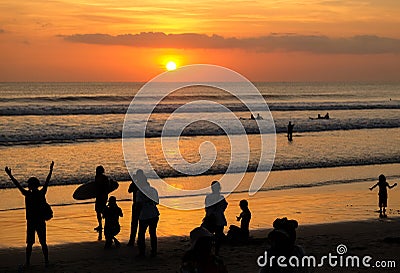 Silhouette of People looking at Sunset at Kuta beach Stock Photo