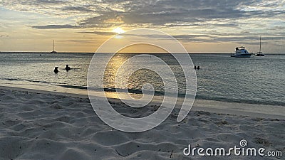 Silhouette of people in the sunset at beach in Aruba Stock Photo