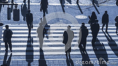 Silhouette people walk on pedestrian crosswalk at the junction s Stock Photo
