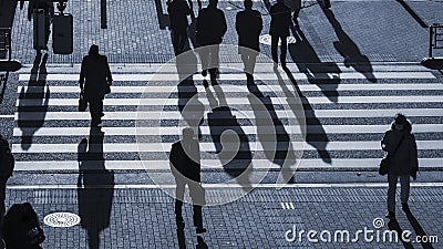 Silhouette people walk on pedestrian crosswalk at the junction Editorial Stock Photo