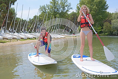 Silhouette perfect couple engage standup paddle boarding Stock Photo