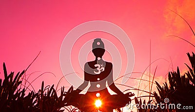 Silhouette of a person doing yoga with the root chakra symbol Stock Photo