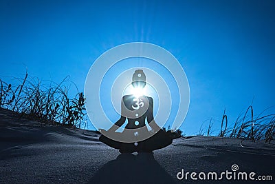 Silhouette of a person meditating with an open throat chakra under the sunlight Stock Photo