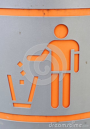 Silhouette of person throwing garbage into a trash can. Stock Photo