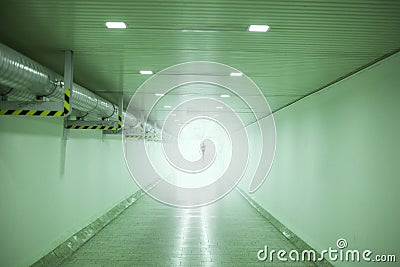 Silhouette of person in underpass tunnel in green Stock Photo
