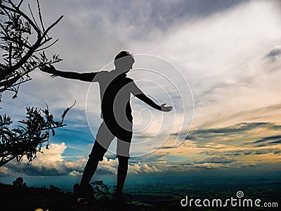 Silhouette Photo of Tourist stand on the cliff in Khao Luang mountain in Ramkhamhaeng National Park Editorial Stock Photo