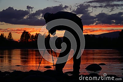 Silhouette of photographer framing a shot Stock Photo