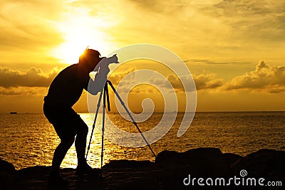 Silhouette photographer at sunset Stock Photo