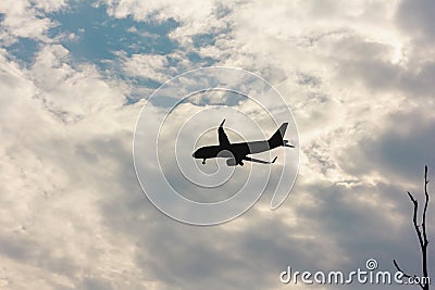 Silhouette plane flying in cloud of the clouds Stock Photo