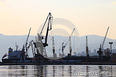 Silhouette of port cranes and ships, harbor of Rijeka, Croatia Stock Photo