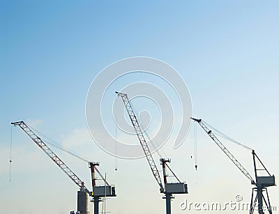 Silhouette of portal cranes in harbor Stock Photo