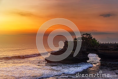 Silhouette of Pura Batu Bolong in golden sunset it the traditional Balinese temple located on a rocky, in the Tanah Lot area, Bali Stock Photo