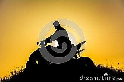 Silhouette of quad bike driver on the mountain Stock Photo
