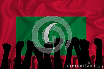 Silhouette of raised arms and clenched fists on the background of the flag of Maldives. The concept of power, conflict. With Stock Photo