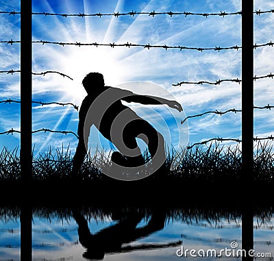 Silhouette of a refugee who illegally cross the border Stock Photo