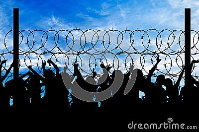 Silhouette of refugees and barbed wire Stock Photo