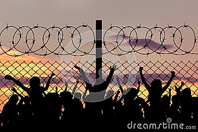 Silhouette of refugees and barbed wire Stock Photo