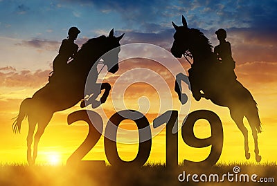 Silhouette the riders on the horse jumping into the New Year 2019. Stock Photo