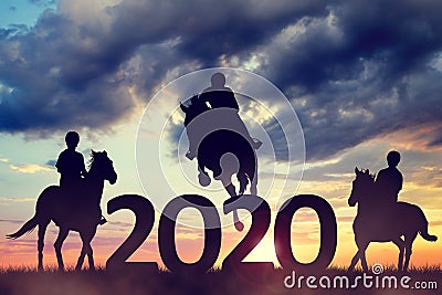 Silhouette of a riders riding a horse in the sunset. New Year 2020 concept. Stock Photo