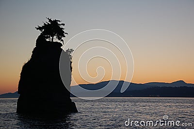 Silhouette of a rock on the ocean Stock Photo