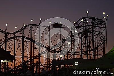Silhouette of rollercoaster at sunset Stock Photo
