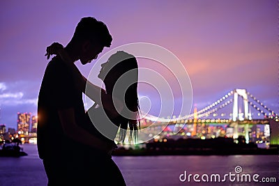 Silhouette romantic lovers with Odaiba Stock Photo