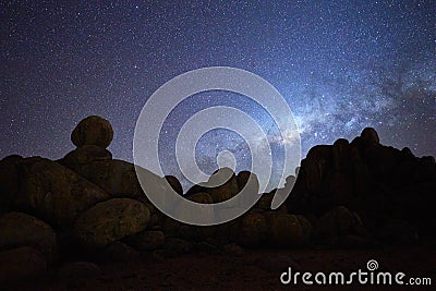 Silhouette of rounded rocky structures against milky way and the stars of african sky. Night sky photo. Twyfelfontein, Madisa, Stock Photo