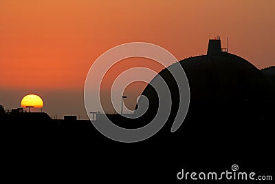 Silhouette of San Onofre nuclear power plant main reactors at sunset with the sun visible Stock Photo