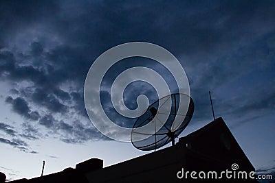 Silhouette satellite dish on house Stock Photo