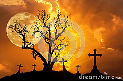 Silhouette scary dead tree and silhouette spooky crosses in mystic graveyard with big full moon. Stock Photo