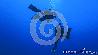 Silhouette scuba diving. Stock Photo