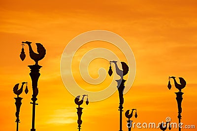 Silhouette, sculpture of golden swan light pole Stock Photo