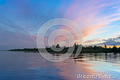 Silhouette of seashore line with forest at the beautiful sunrise Stock Photo