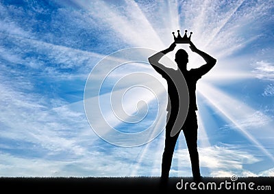 Silhouette of a selfish and narcissistic man reconciling his own crown Stock Photo