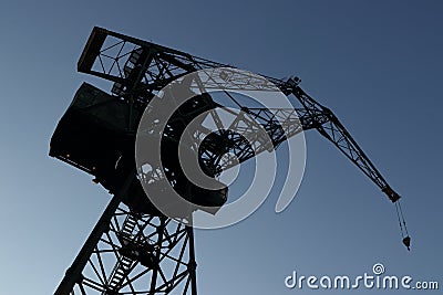 Silhouette of shipyard`s tall crane. Editorial Stock Photo