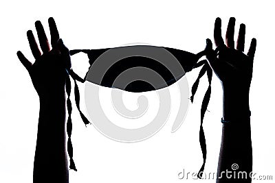 Silhouette shot of a woman's hand raising her facemask isolated on a white background Stock Photo