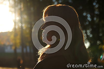 Silhouette side view of smiling woman looking at sunset. Mental health, hope, happiness concept. Dream autumn. Peace Stock Photo