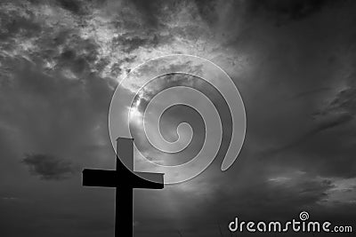 Silhouette of a simple catholic cross, dramatic stormclouds after heavy rain Stock Photo