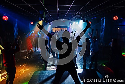 Silhouette of the singer at a live concert at the club at the event against the crowd Editorial Stock Photo