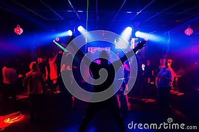 Silhouette of the singer at a live concert at the club at the event against the crowd Editorial Stock Photo