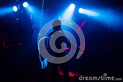 Silhouette of the singer at a live concert at the club at the event against the crowd Editorial Stock Photo