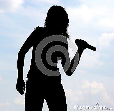 Silhouette Of Singing Girl Stock Photo