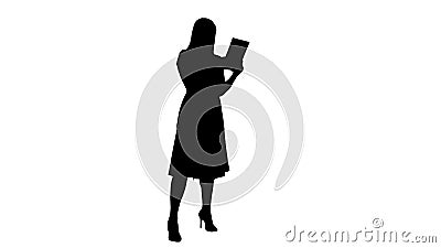 Silhouette Single girl making a video call on her tablet side view full lenth. Stock Photo