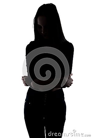 Silhouette slim woman with arms crossed Stock Photo