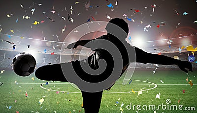 Silhouette soccer player kicking the ball Stock Photo