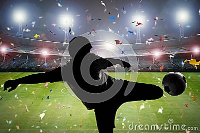 Silhouette soccer player kicking the ball Stock Photo