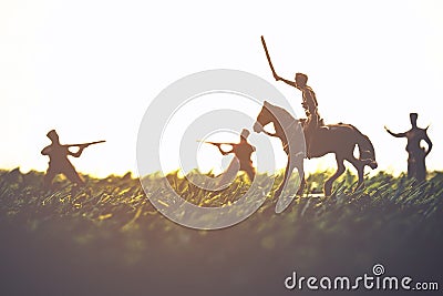 Silhouette of a soldier with a gun on grass Stock Photo