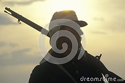 Silhouette of soldier at sunset with gun during reenactment of Battle of Manassas marking the beginning of the Civil War Editorial Stock Photo