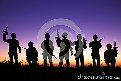 Silhouette of Soldiers team with sunrise background Stock Photo